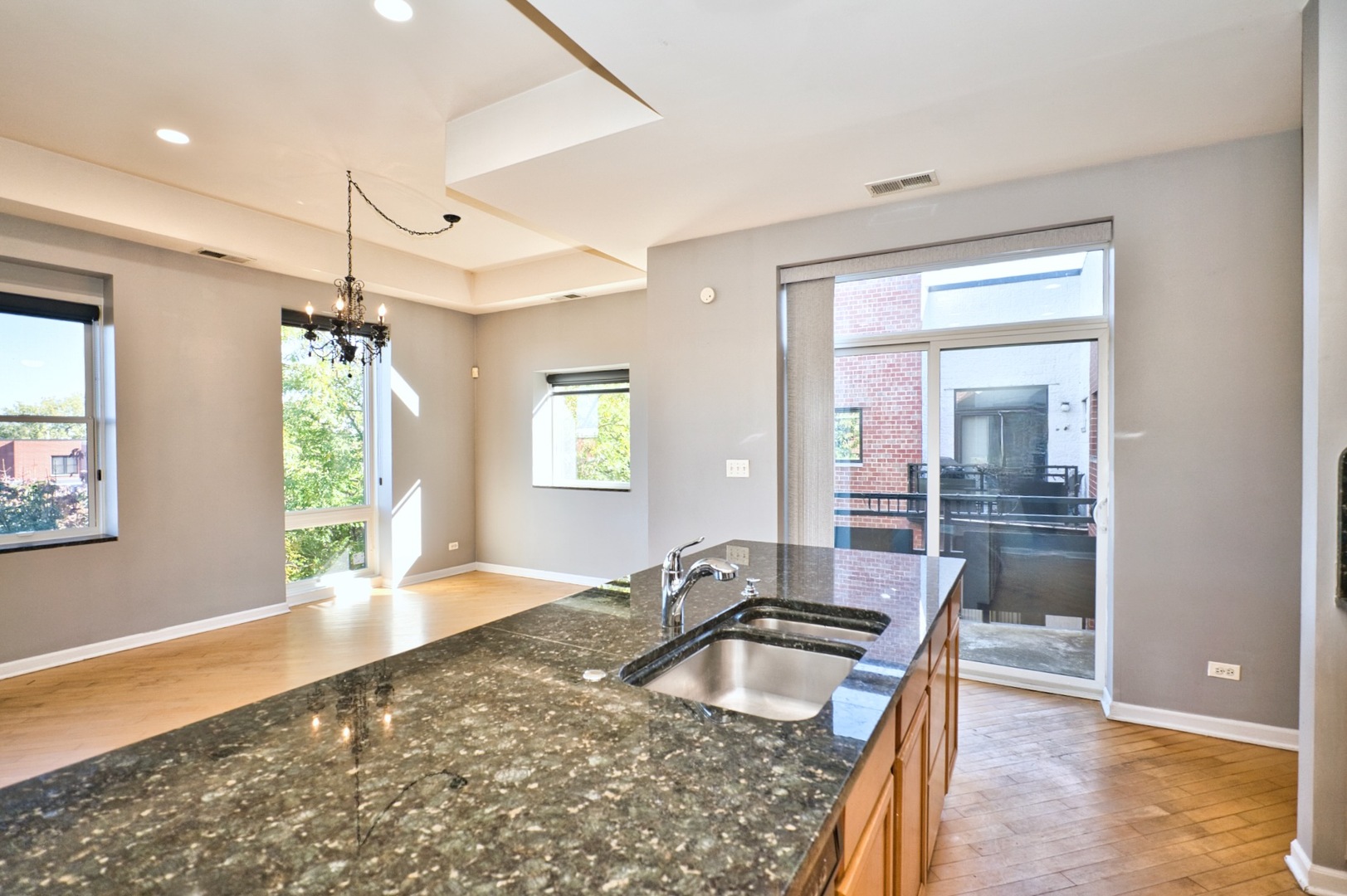 2317 West Wolfram Street, Unit 515 Chicago, IL 60618 - Photo 14 of 35 a kitchen with granite countertop a sink and a window