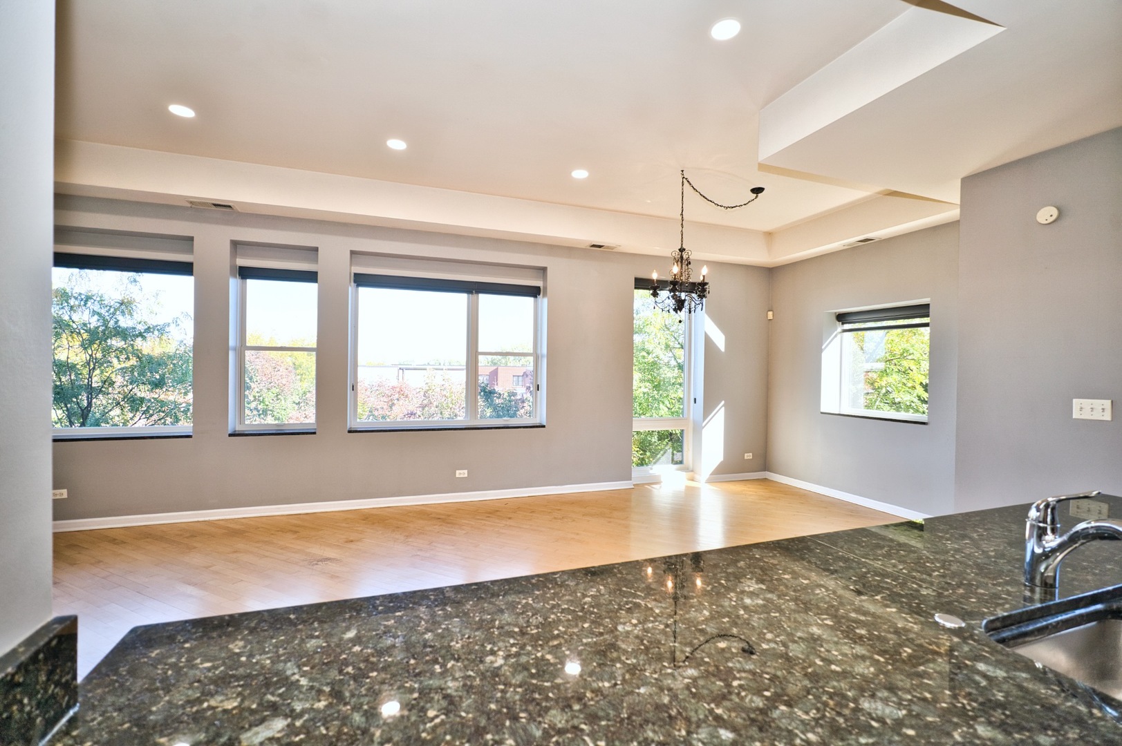 2317 West Wolfram Street, Unit 515 Chicago, IL 60618 - Photo 15 of 35 a view of an empty room with window and wooden floor