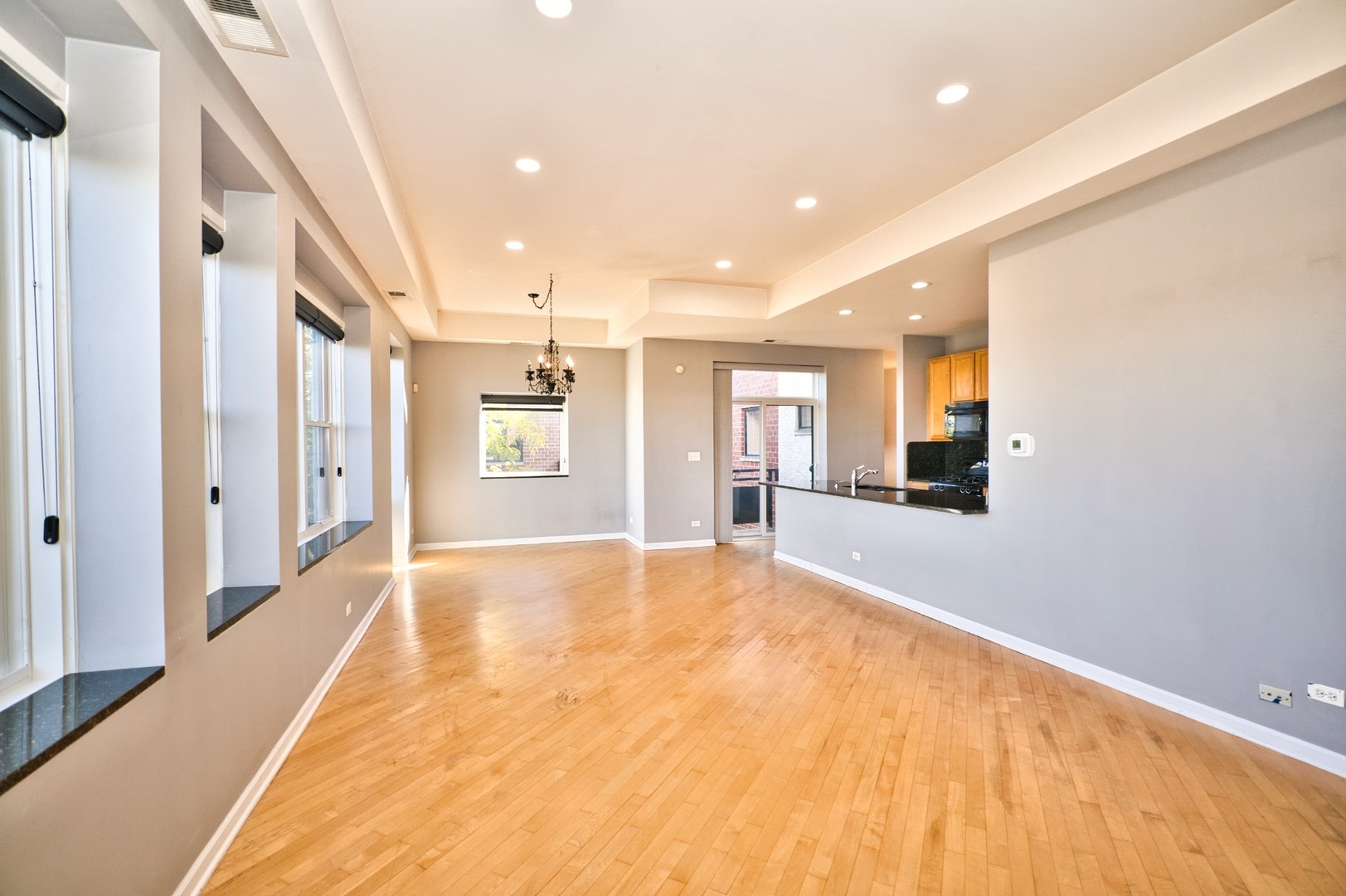 2317 West Wolfram Street, Unit 515 Chicago, IL 60618 - Photo 5 of 35 a view of an empty room with kitchen and a window