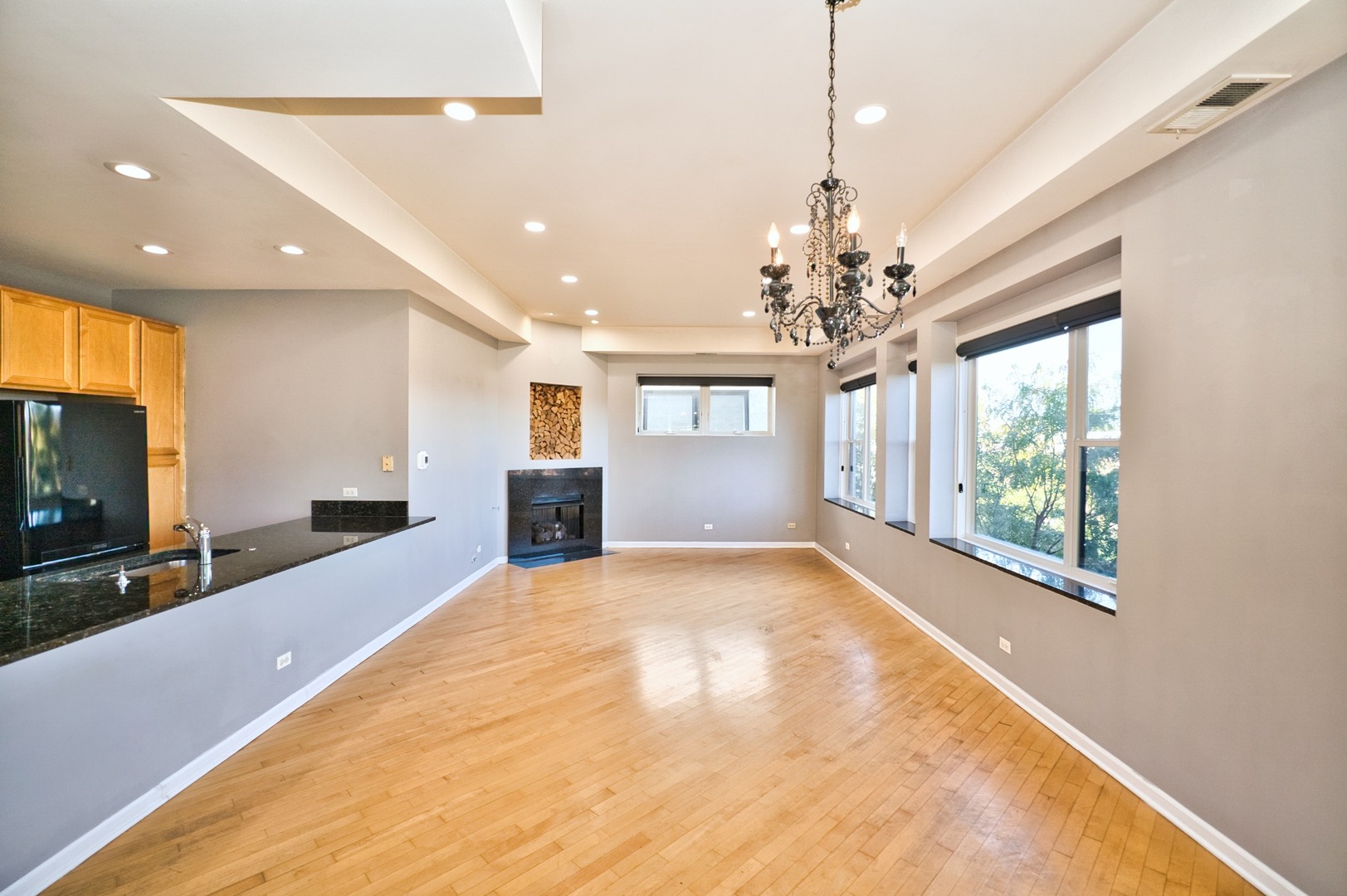 2317 West Wolfram Street, Unit 515 Chicago, IL 60618 - Photo 6 of 35 a view of an empty room with a window and kitchen view