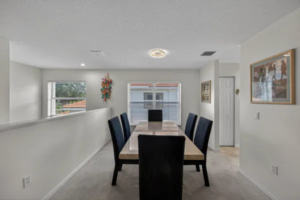 a view of a dining room with furniture and window