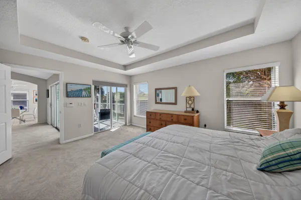 a large bedroom with a large bed and a chandelier