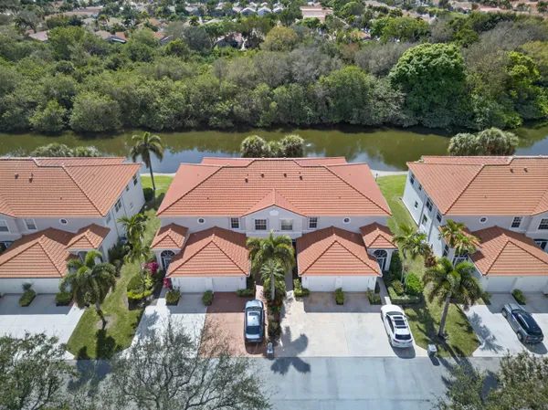 an aerial view of house with yard and ocean view
