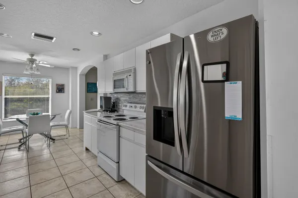 a kitchen with stainless steel appliances granite countertop a refrigerator and a stove