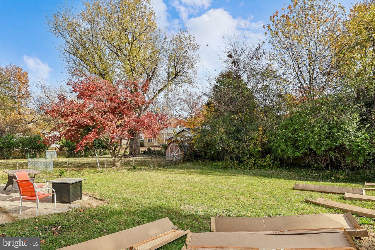 617 Denham Road Rockville, MD 20851 - Photo 30 of 31 Serene backyard with vibrant autumn hues.