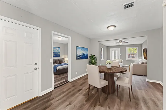 a view of a dining room with furniture and wooden floor