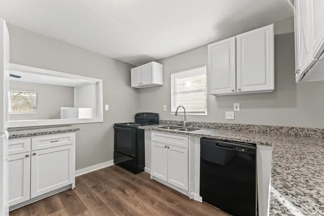 a kitchen with a sink stove and cabinets
