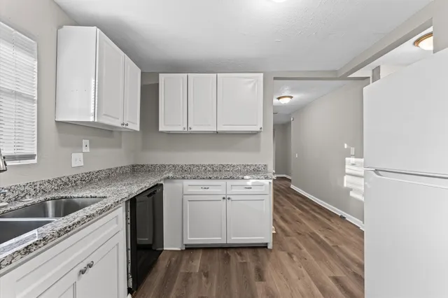 a kitchen with a sink stove and cabinets