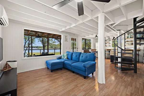 a living room with furniture and wooden floor