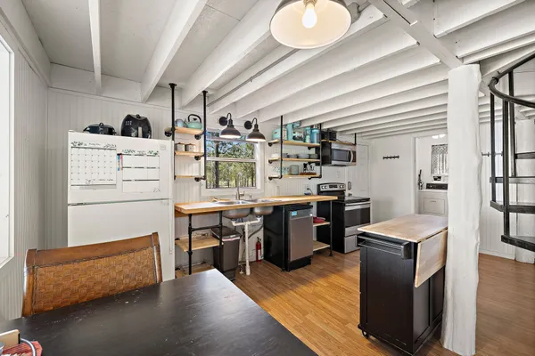 a kitchen with a refrigerator and a stove