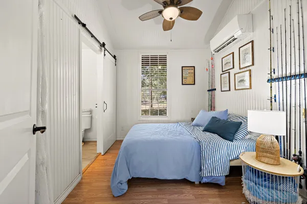 a bedroom with a bed and a chandelier
