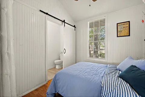 a bedroom with a bed and a window