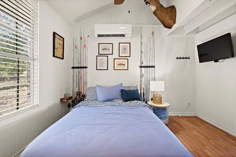 a bedroom with a bed and wooden floor