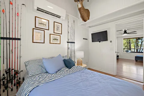 a bedroom with a bed and a flat screen tv