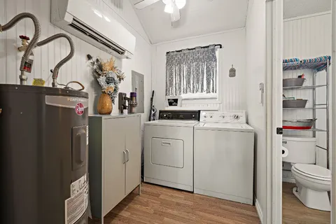 a view of storage and utility room with a washer dryer