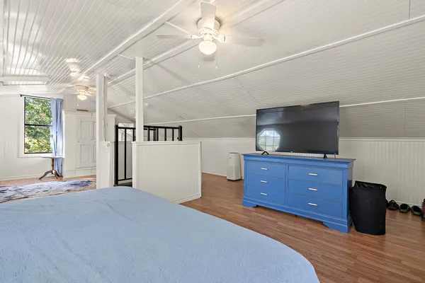 a bedroom with a bed and a flat screen tv