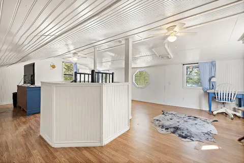 a balcony with furniture and wooden floor