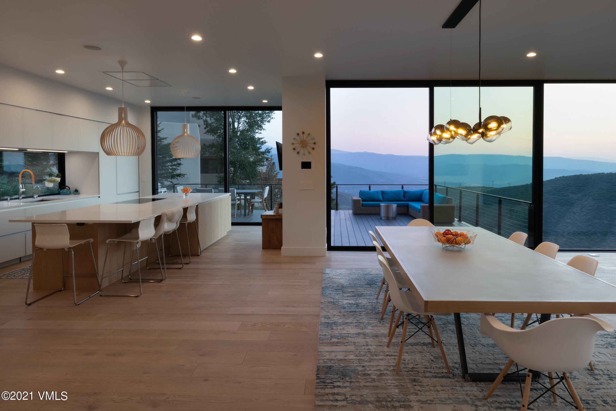 4380 June Point Avon, CO 81620 - Photo 11 of 39 a view of kitchen with stainless steel appliances granite countertop dining table chairs sink and wooden floor
