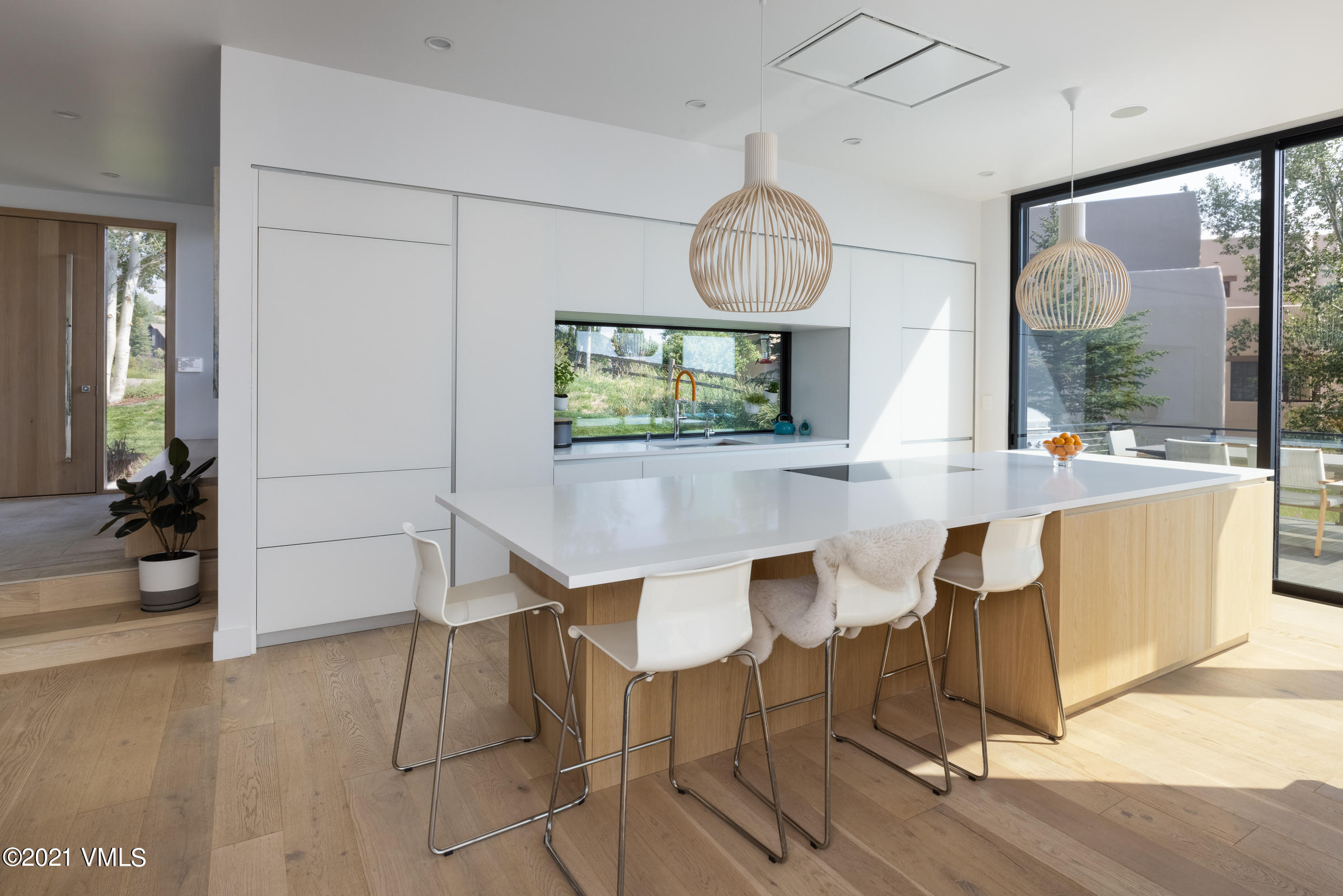 4380 June Point Avon, CO 81620 - Photo 13 of 39 a dining room with wooden floor a glass table and chairs