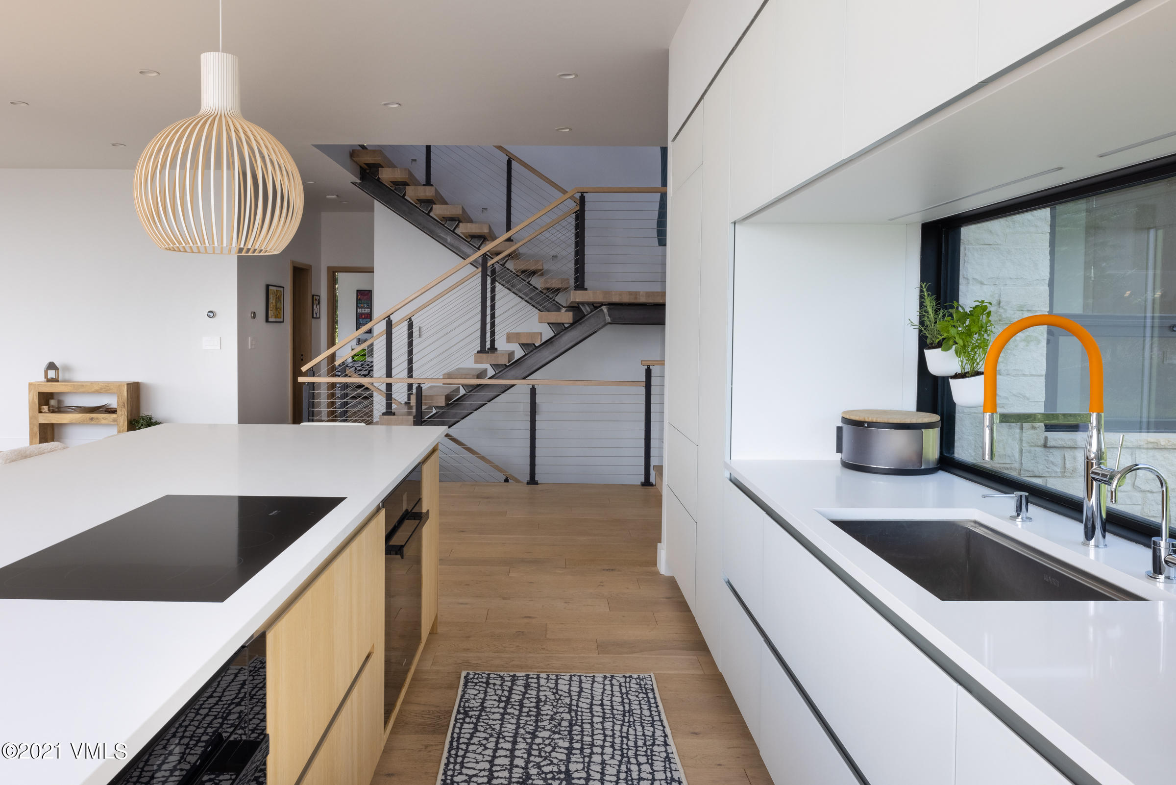 4380 June Point Avon, CO 81620 - Photo 15 of 39 a kitchen with kitchen island a counter appliances and a sink