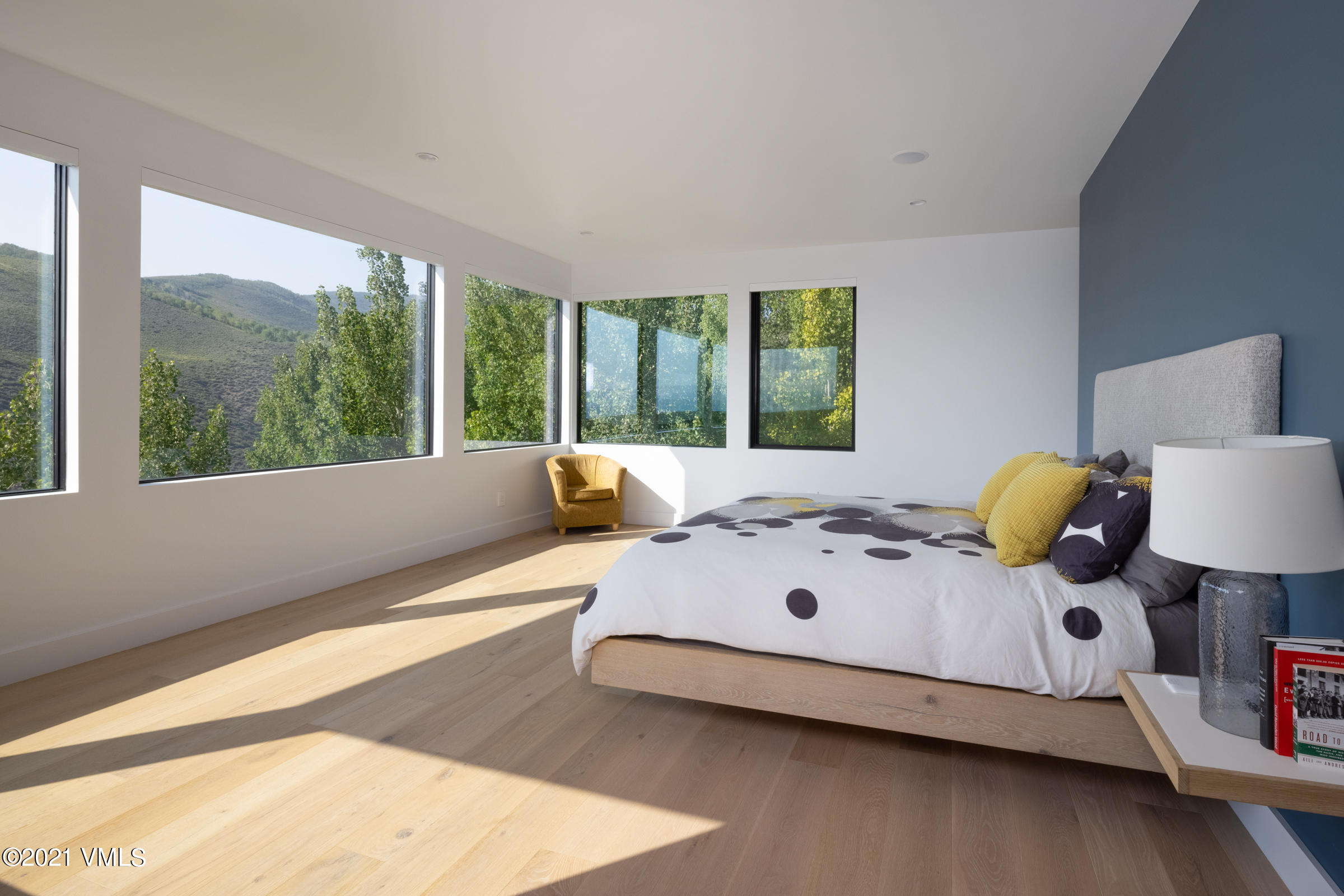 4380 June Point Avon, CO 81620 - Photo 19 of 39 a large white bed sitting in a bedroom next to a window