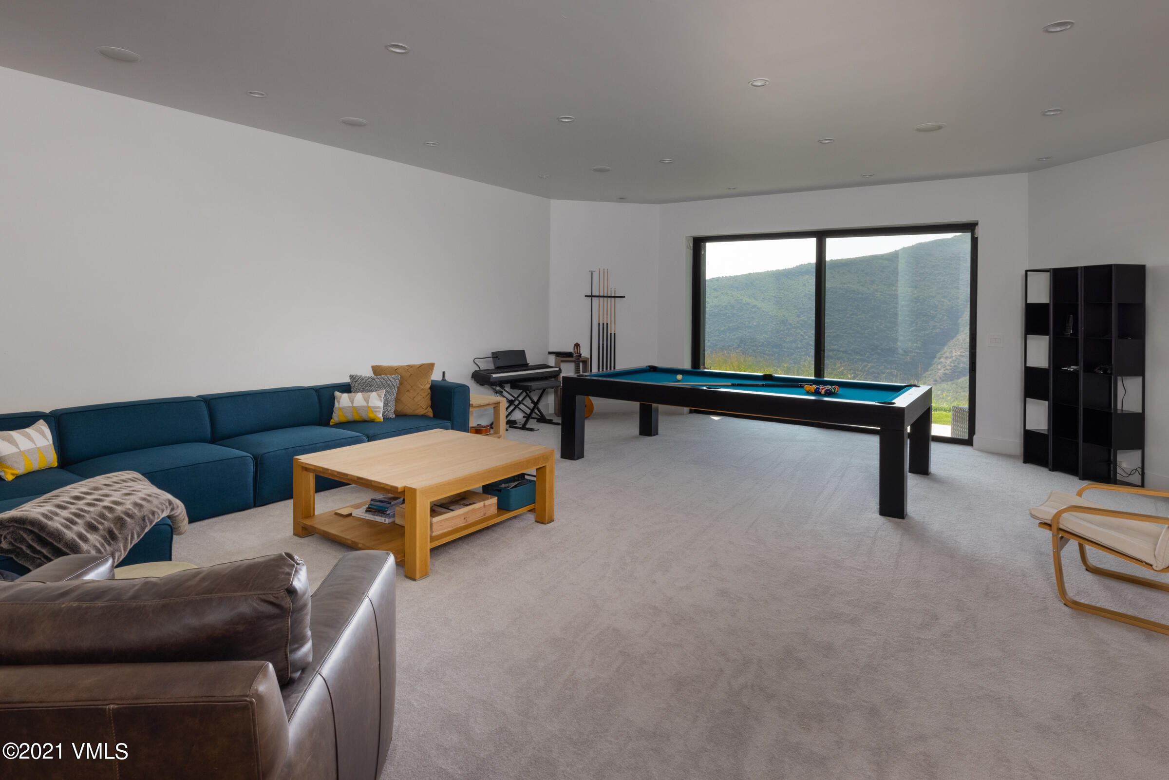 4380 June Point Avon, CO 81620 - Photo 26 of 39 a living room with furniture gym equipment and a large window