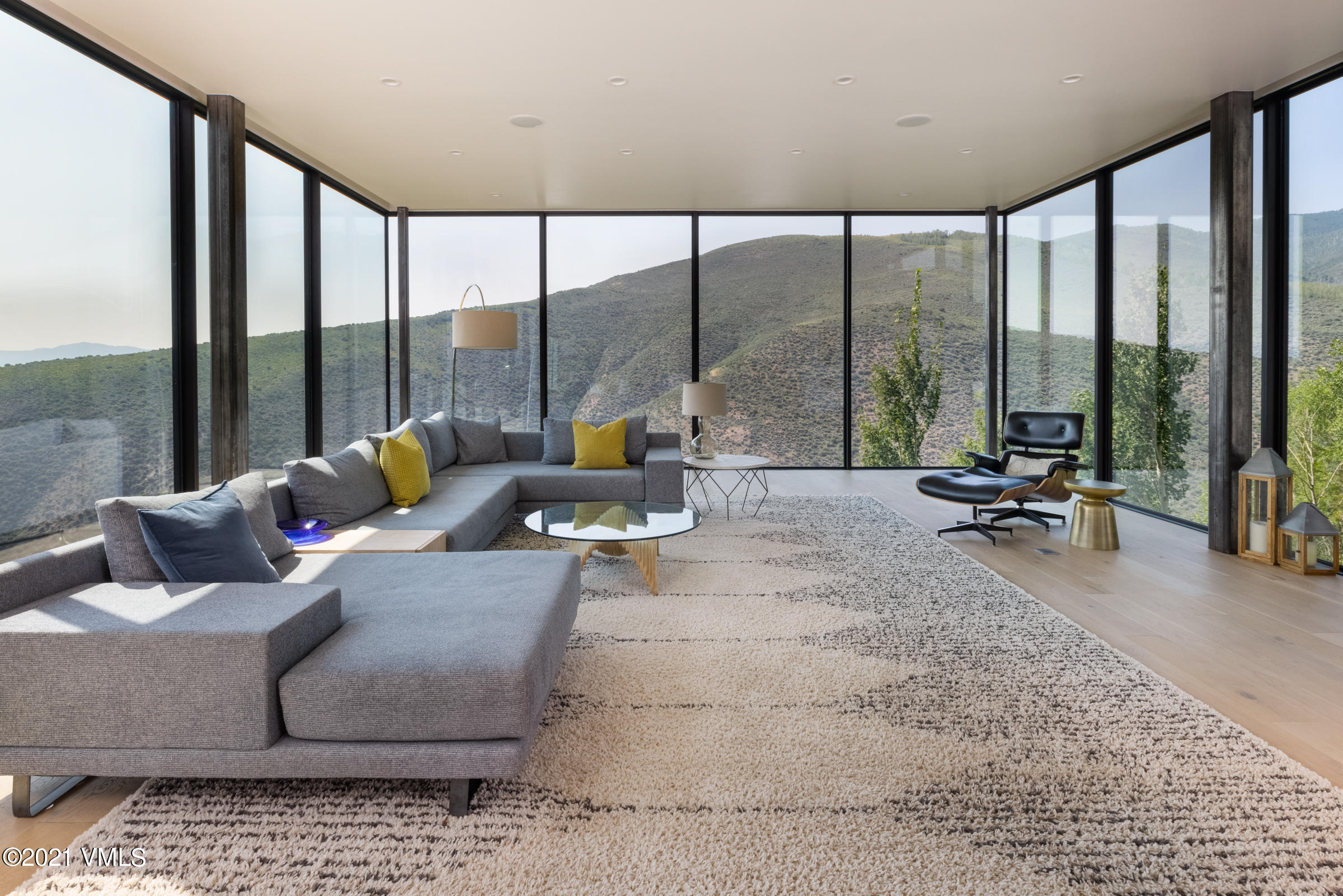 4380 June Point Avon, CO 81620 - Photo 5 of 39 a living room with furniture and floor to ceiling windows