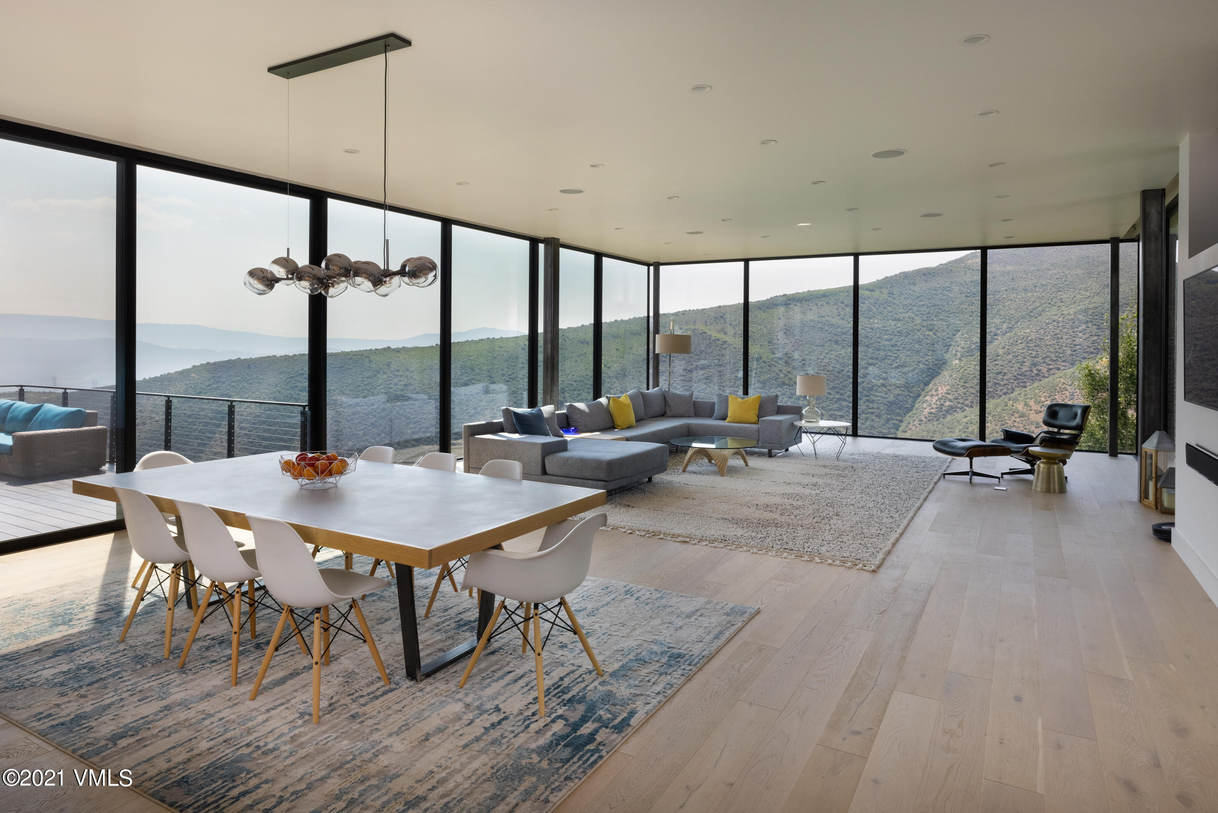 4380 June Point Avon, CO 81620 - Photo 6 of 39 a view of a sitting area with furniture and floor to ceiling windows