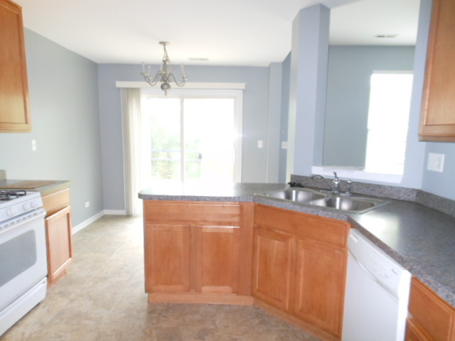 603 Conservatory Lane Aurora, IL 60502 - Photo 6 of 18 a kitchen with stainless steel appliances granite countertop a sink stove and granite counter tops