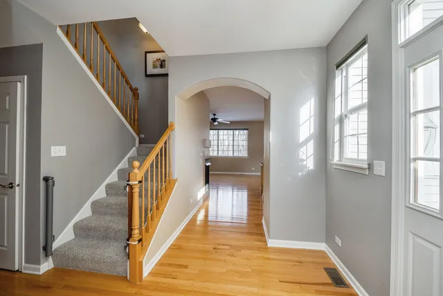 a view of a hallway with wooden floor and entryway
