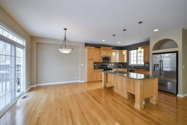 a view of kitchen with cabinets and wooden floor