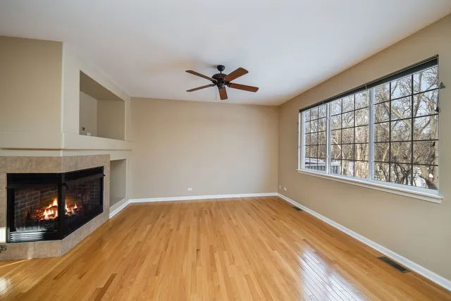 a view of a livingroom with a fireplace and wooden floor