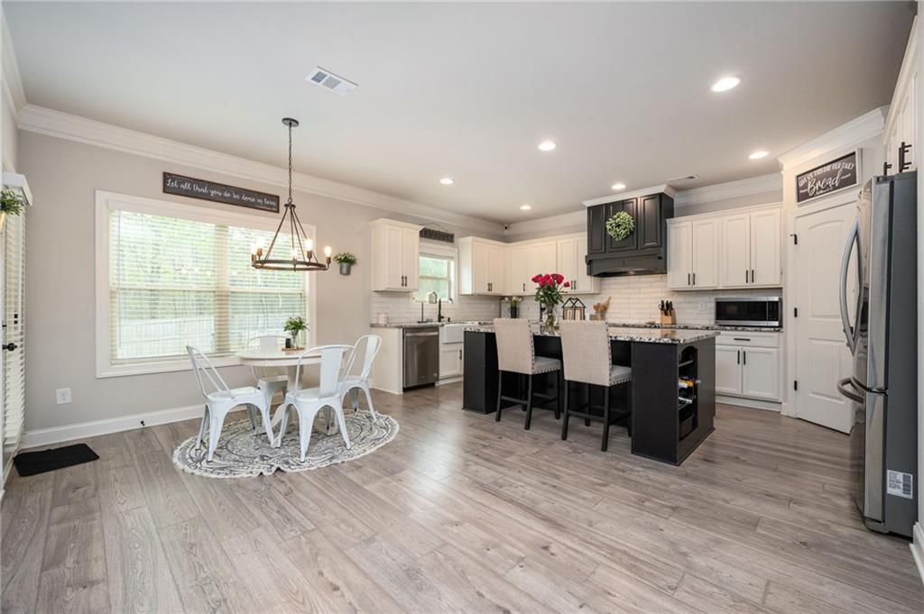 4575 Birch Way Loganville, GA 30052 - Photo 11 of 40 a large kitchen with a table and chairs