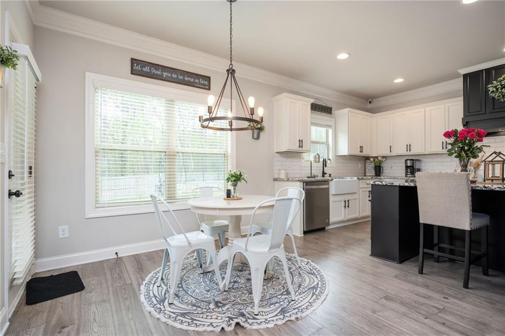 4575 Birch Way Loganville, GA 30052 - Photo 12 of 40 a kitchen with kitchen island granite countertop a sink and white cabinets