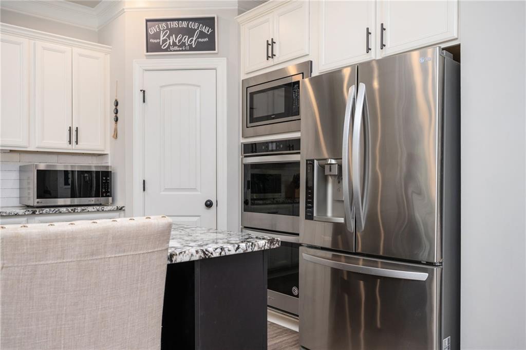 4575 Birch Way Loganville, GA 30052 - Photo 15 of 40 a kitchen with stainless steel appliances and refrigerator