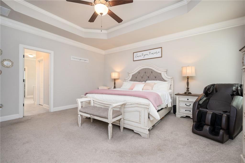 4575 Birch Way Loganville, GA 30052 - Photo 20 of 40 a spacious bedroom with a bed and ceiling fan
