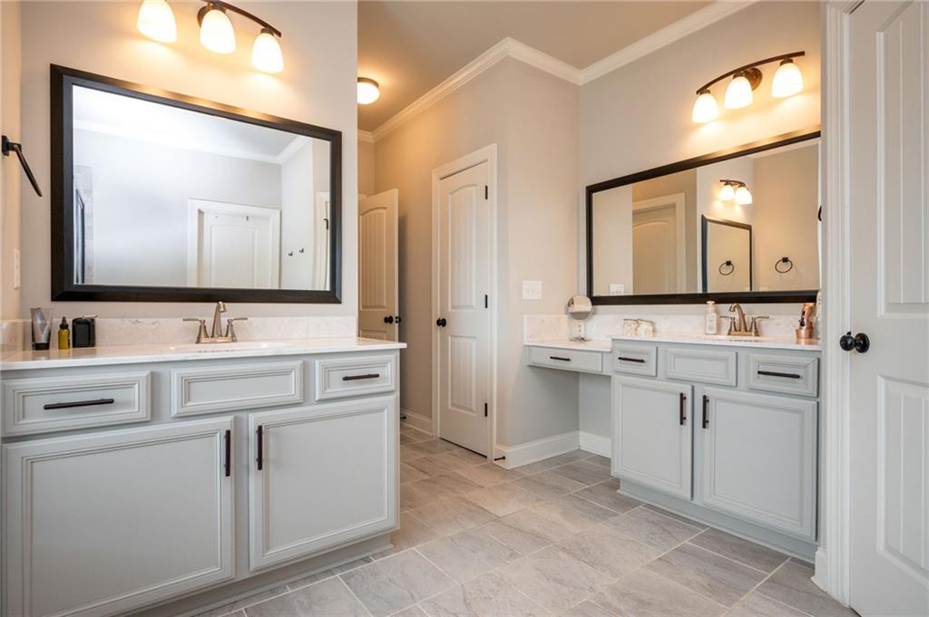 4575 Birch Way Loganville, GA 30052 - Photo 23 of 40 a bathroom with a double vanity sink mirror and