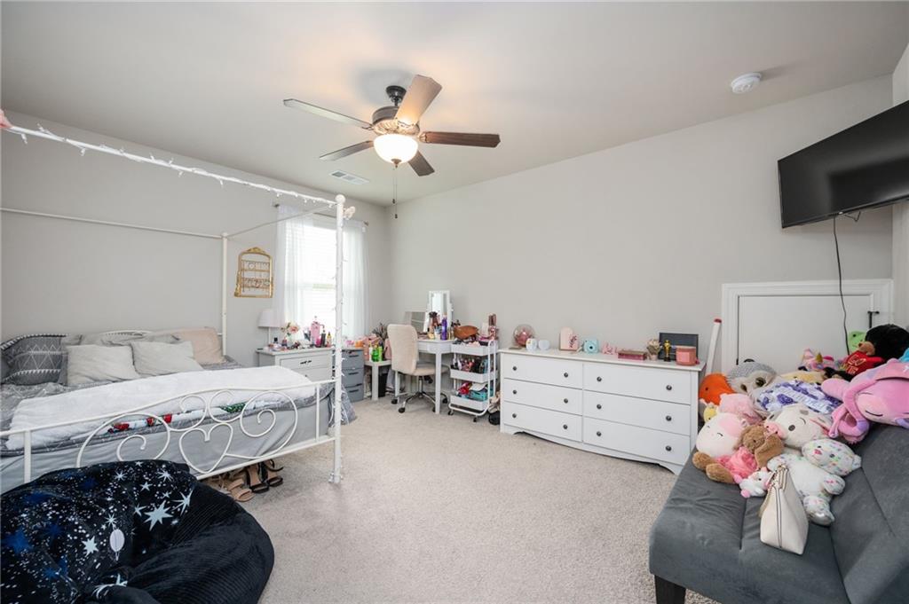 4575 Birch Way Loganville, GA 30052 - Photo 25 of 40 a room with a bed and a tv