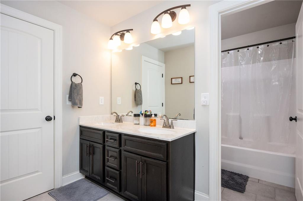 4575 Birch Way Loganville, GA 30052 - Photo 26 of 40 a bathroom with a double vanity sink mirror and bathtub
