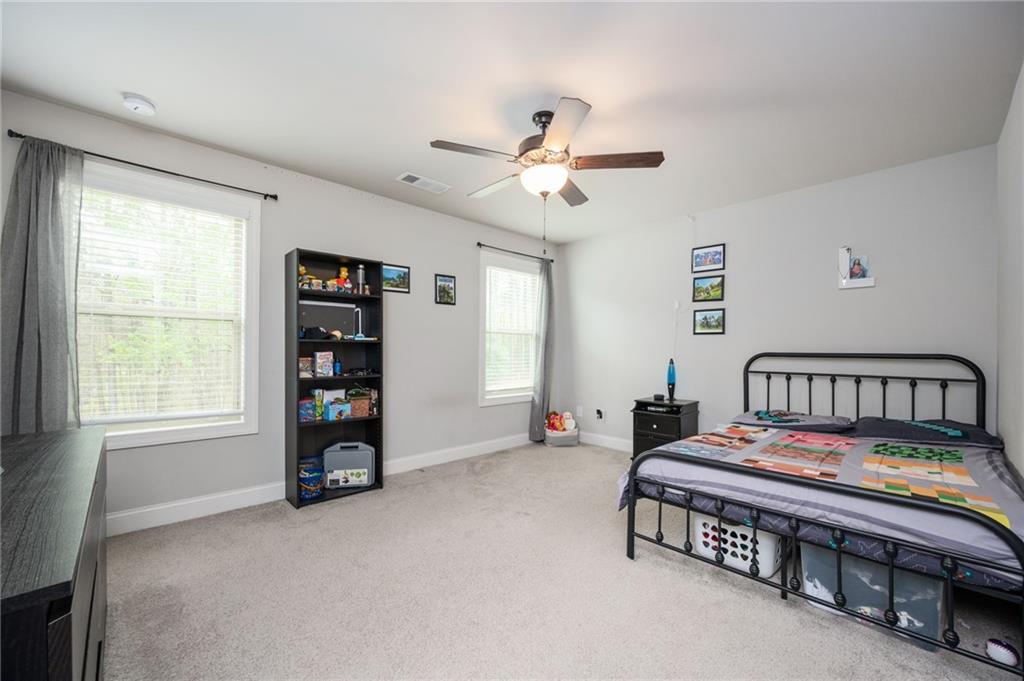 4575 Birch Way Loganville, GA 30052 - Photo 27 of 40 a bedroom with bed and a window