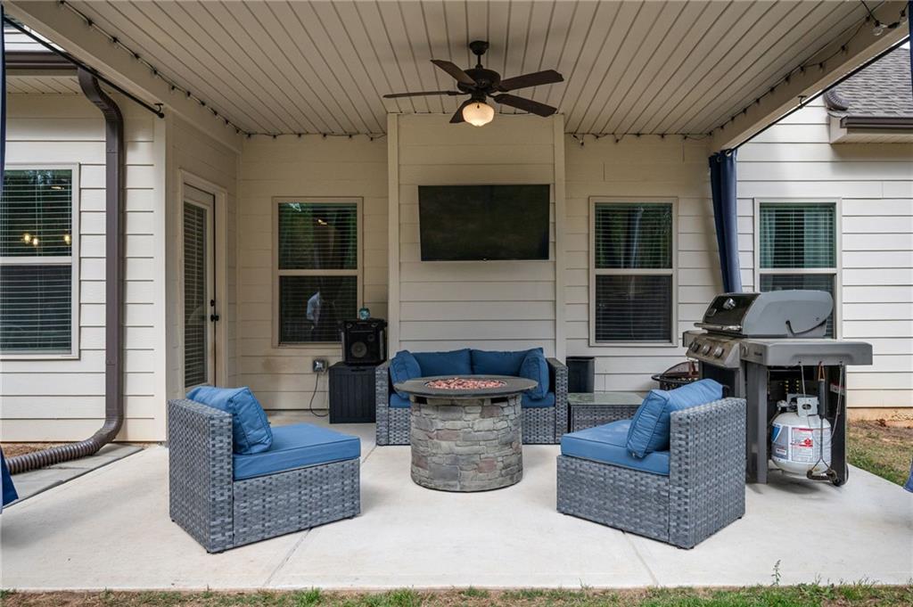 4575 Birch Way Loganville, GA 30052 - Photo 31 of 40 a living room with fireplace furniture and a flat screen tv