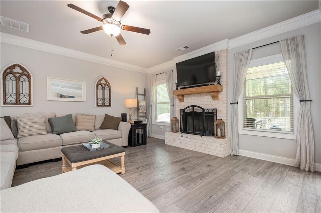 4575 Birch Way Loganville, GA 30052 - Photo 8 of 40 a living room with furniture a flat screen tv and a fireplace