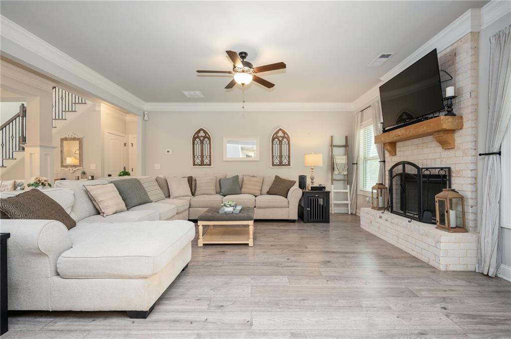 4575 Birch Way Loganville, GA 30052 - Photo 9 of 40 a living room with furniture a fireplace and a flat screen tv