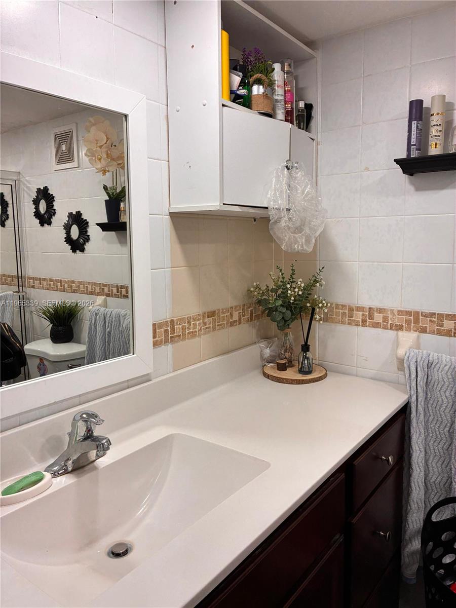 1900 West 68th Street, Unit G103 Hialeah, FL 33014 - Photo 12 of 20 a bathroom with a sink and a mirror