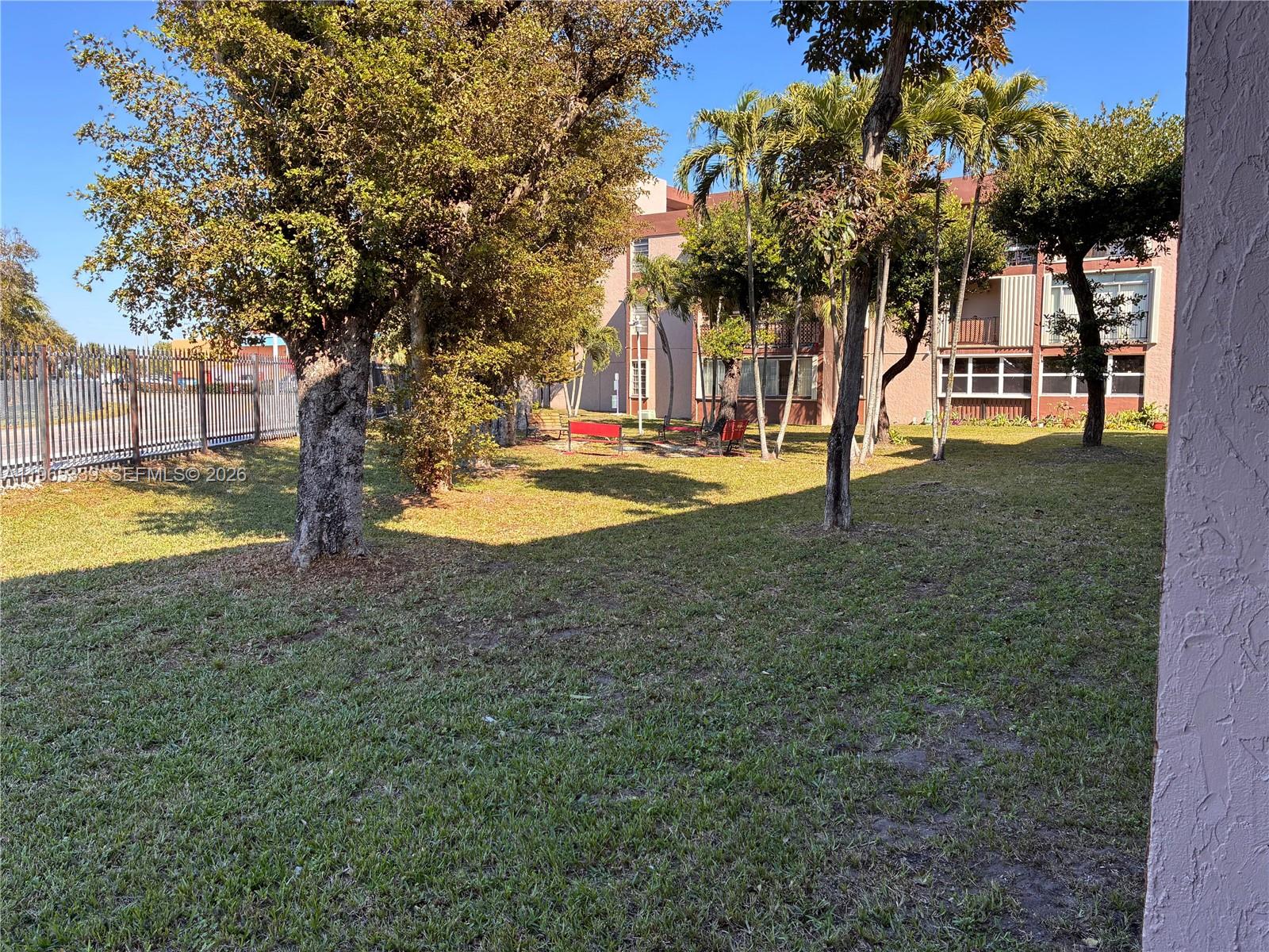 1900 West 68th Street, Unit G103 Hialeah, FL 33014 - Photo 18 of 20 a view of a house with swimming pool and a yard