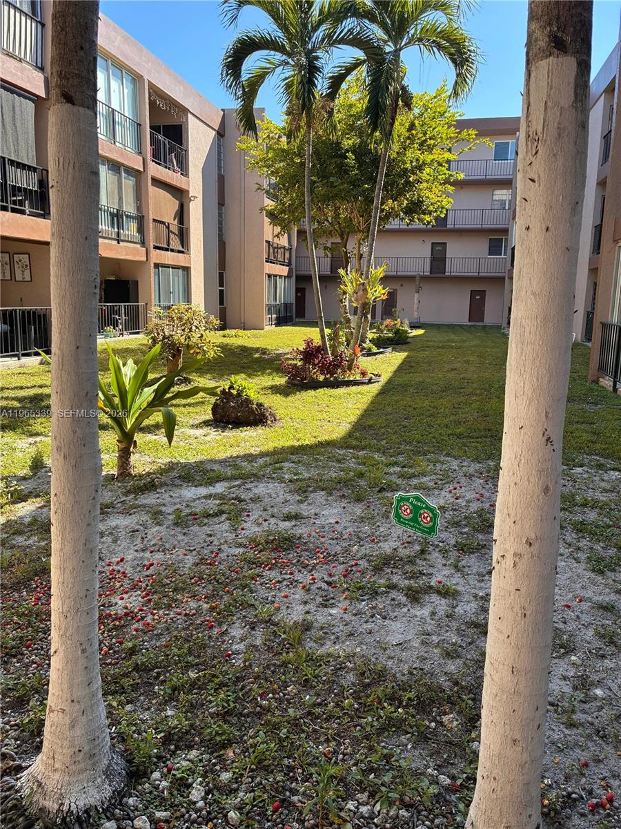 1900 West 68th Street, Unit G103 Hialeah, FL 33014 - Photo 19 of 20 a view of a house with a backyard