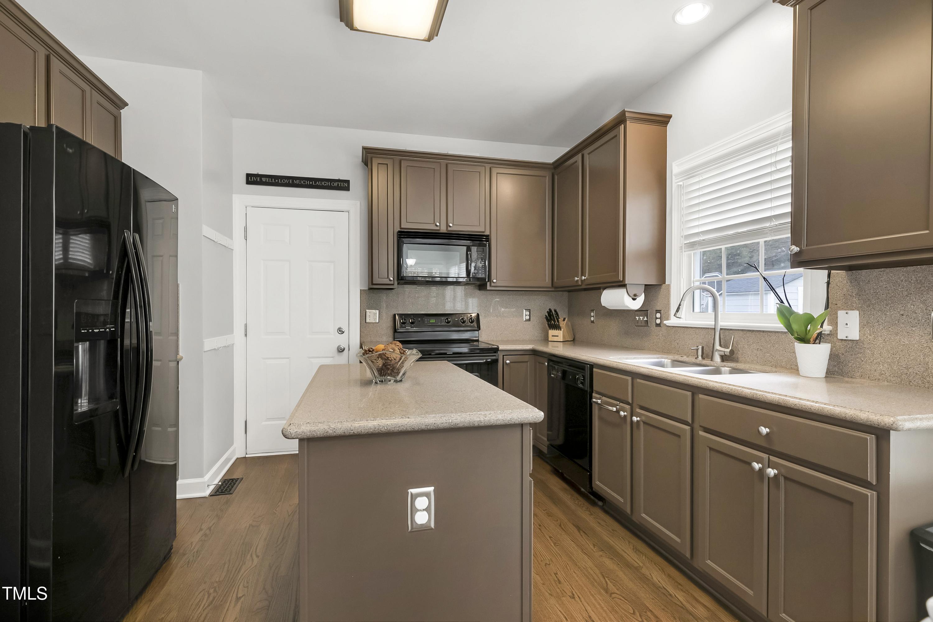 102 Kenneil Court Apex, NC 27502 - Photo 14 of 55 a kitchen with stainless steel appliances granite countertop a sink stove refrigerator and cabinets