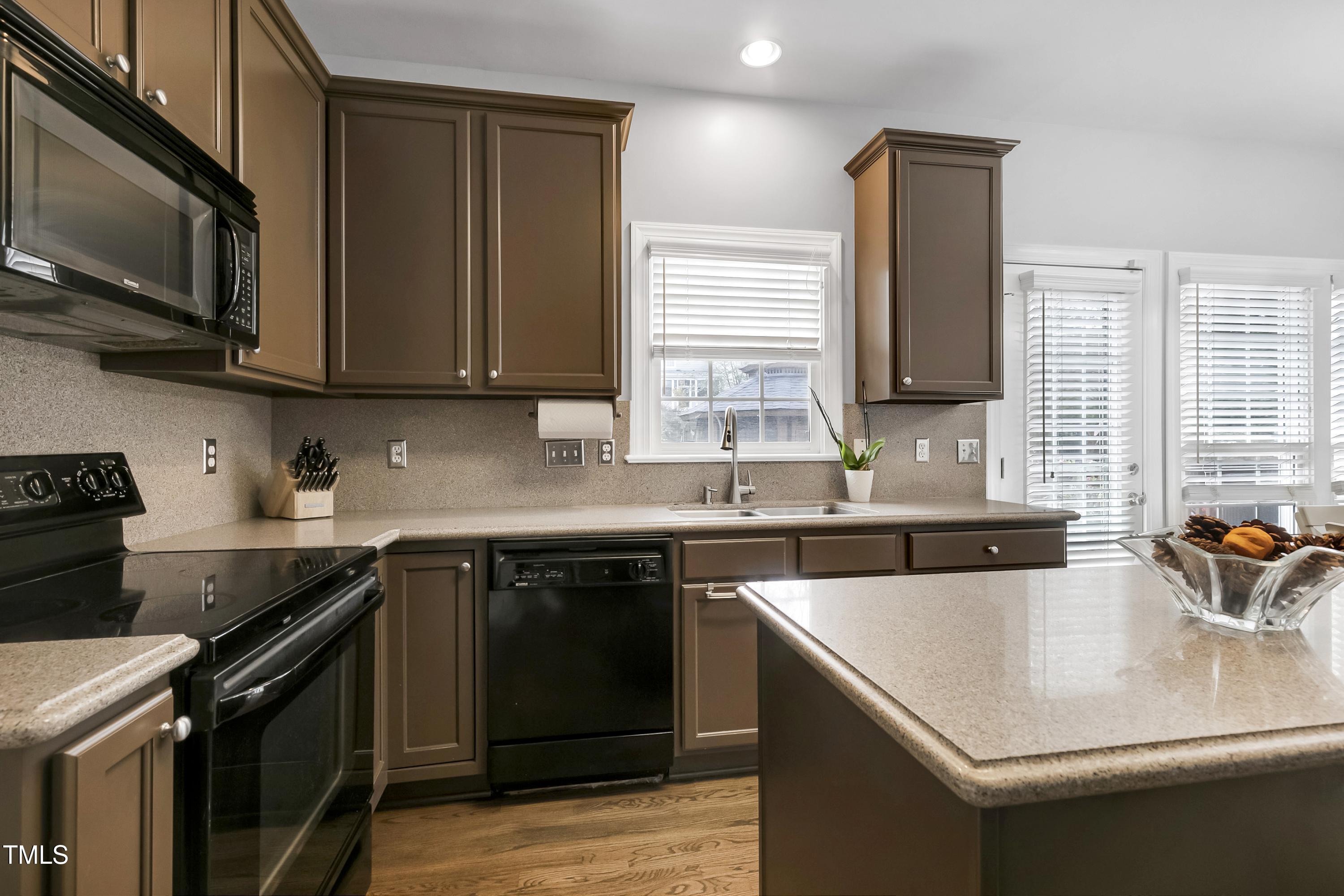 102 Kenneil Court Apex, NC 27502 - Photo 16 of 55 a kitchen with stainless steel appliances granite countertop a sink stove and microwave