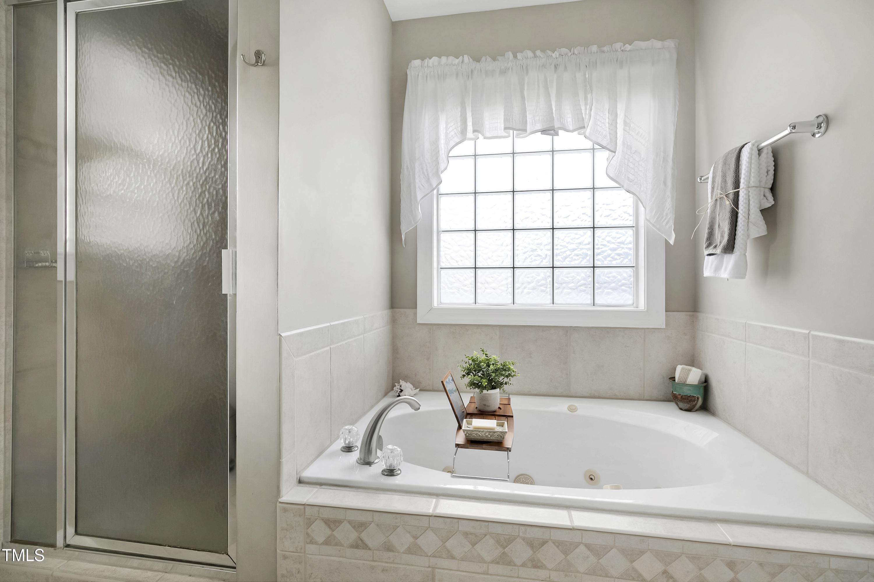 102 Kenneil Court Apex, NC 27502 - Photo 24 of 55 a bathroom with a tub and sink