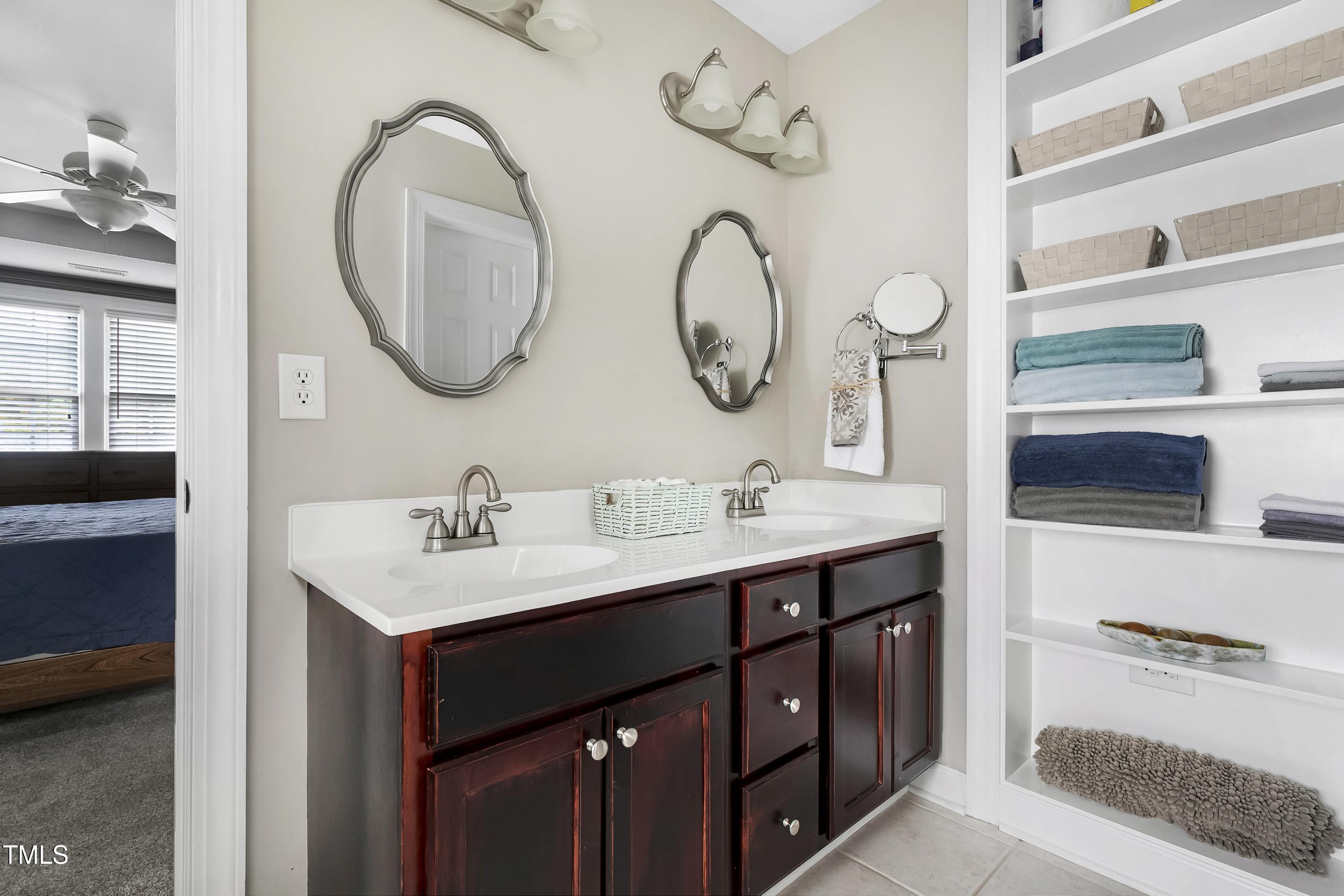 102 Kenneil Court Apex, NC 27502 - Photo 25 of 55 a bathroom with a double vanity sink and a mirror